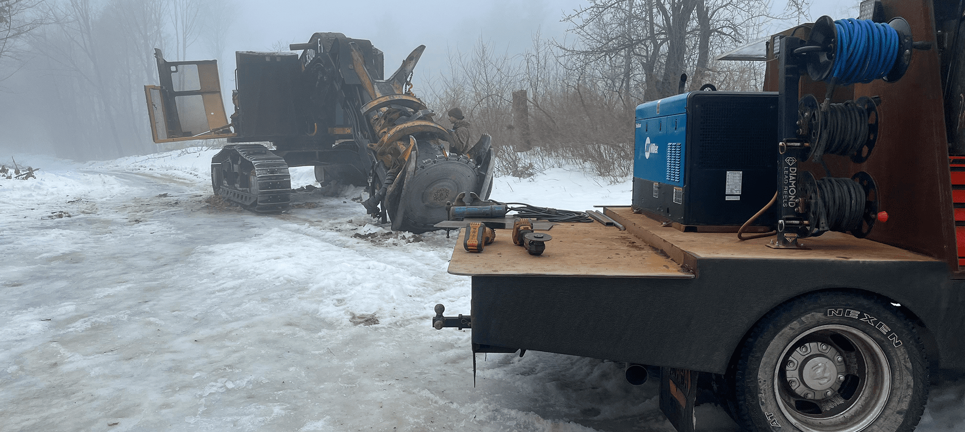 Icy road with machinery in fog